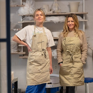 Staff wearing the Studio Pottery London apron with logo